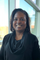 Melinda wearing black blouse smiles at the camera.
