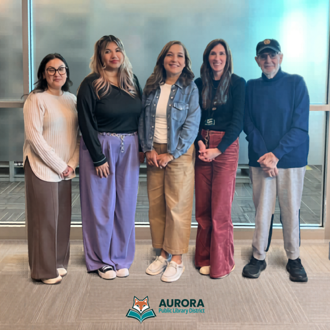 APLD staff and committee members stand for a group photo during a meeting at the library.