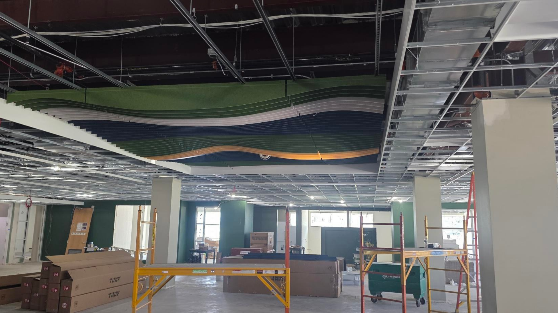 Wavy ceiling treatments with pops up color in the children's department.